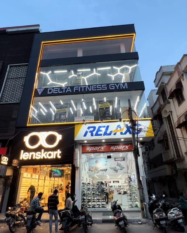 The building with the lit-up Delta Fitness Gym sign above the Relaxo showroom