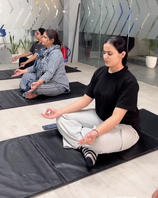 A yoga class in the glass-walled group studio